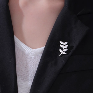 Elegant silver leaf branch brooch pin in stainless steel on black suit lapel