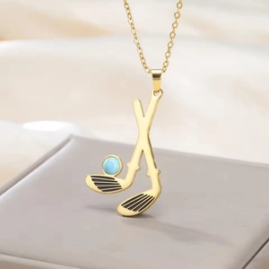 Macro shot of gold golf club pendant with light blue bead on a fine 304 stainless steel chain