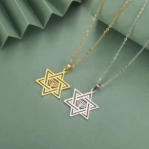 Detalle de colgantes Estrella de David en oro y plata con Menorah sobre papel verde