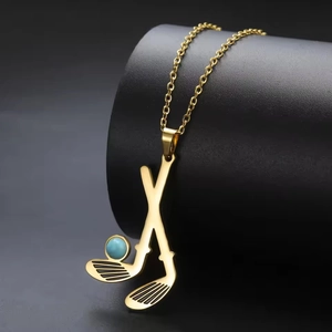 Detail of golf club pendant necklace in gold finish with a light blue bead accent