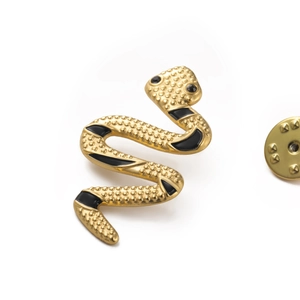 Punk style snake brooch in gold stainless steel with black enamel stripes and textured finish