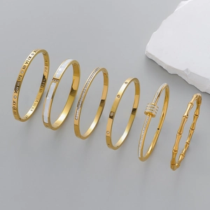 Set of six gold-plated stainless steel bangles with Roman numerals and crystal accents