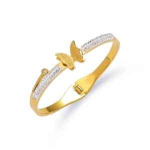 Detail of gold titanium butterfly bracelet with sparkling zircon stones and matte finish