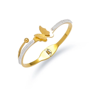 Macro shot of gold butterfly bangle with frosted texture and sparkling zircon inlay