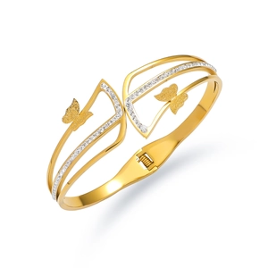 Macro detail of golden butterfly bangle featuring frosted wings and sparkling zircon pavé