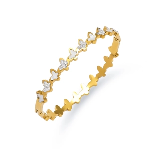 Close-up of gold butterfly bracelet with white mother-of-pearl and sparkling zircon stones