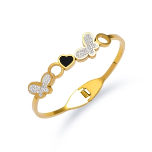 Detailed close-up of gold-plated butterfly spring bangle with black heart and zircons