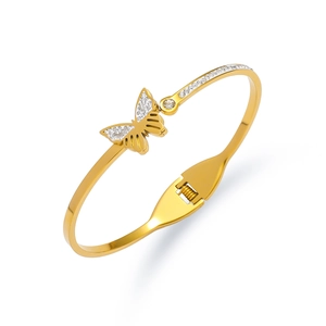 Detail of gold butterfly bangle featuring spring hinge and shimmering zircon stones