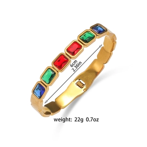 Detail view of gold stainless steel bangle with colorful gemstones and 6cm inner diameter size