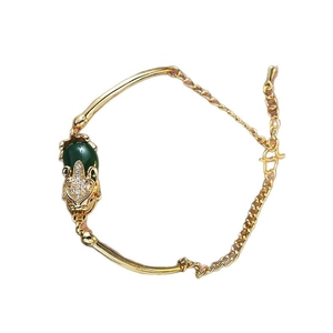 Vintage vergoldetes Armband mit dunkelgrünem Edelstein und Tier-Charm-Anhänger