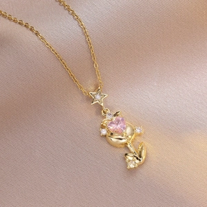 Elegant gold necklace featuring a pink heart stone pendant and sparkling star detail