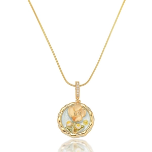 Detail of gold floral enamel pendant with pearl accents on a sleek snake chain
