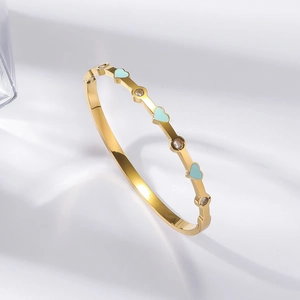 Polished 18K gold bangle with light blue enamel hearts and sparkling zircon stones