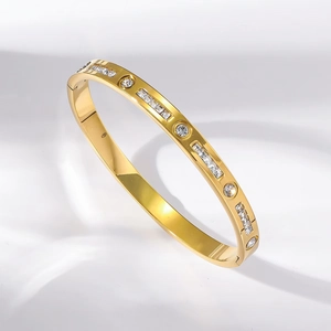 Elegant gold titanium steel bracelet with alternating round and rectangular stone settings