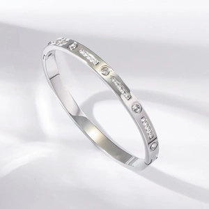 Polished silver titanium steel bangle with heart-shaped sparkling crystals for women