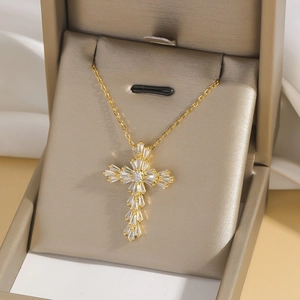 Gold stainless steel necklace with sparkling crystal cross pendant in a jewelry box
