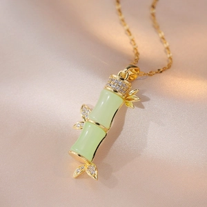 Elegant gold chain necklace with green bamboo pendant and sparkling zircon accents