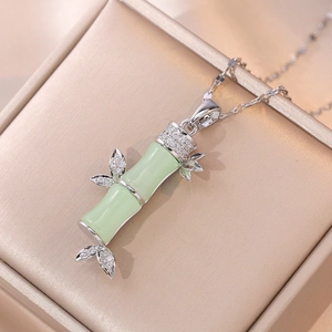 Bamboo style pendant necklace with green resin nodes and silver leaf accents