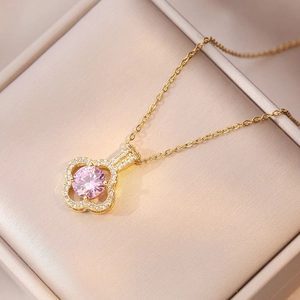 Elegant gold clover necklace featuring a large pink zircon stone and silk gift box