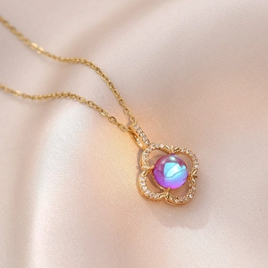 Elegant gold clover necklace with iridescent blue-purple stone and zircon accents
