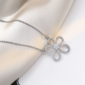Elegant silver flower necklace with sparkling white crystals on a satin background