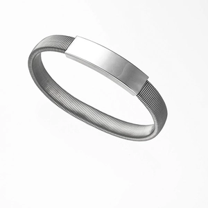 Dettaglio macro del bracciale flessibile in acciaio argento con piastrina ID rettangolare