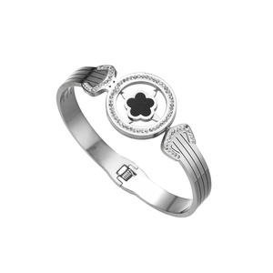Detailed macro view of the polished five-leaf flower clasp and pave crystal settings