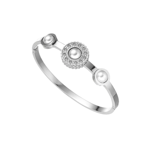 Detailed side view of silver ring bracelet with white faux pearls and zircon accents