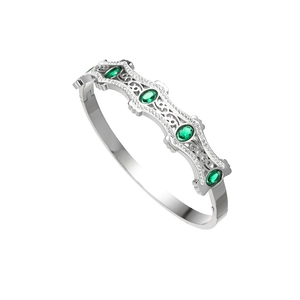 Detalle de brazalete ondulado plateado con cinco piedras verdes ovales y cristales blancos