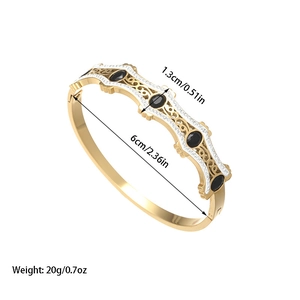 Brazalete vintage dorado con piedras negras ovaladas y finos cristales brillantes