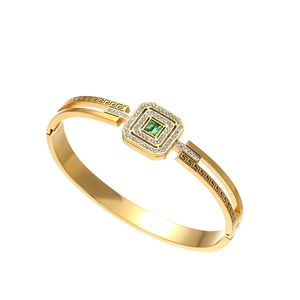 Gold-plated hollow bangle with green gemstone and Greek key patterns in minimalist style