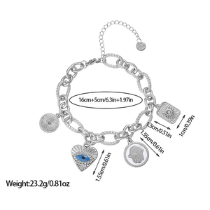 Detail view of steel link bracelet with Hamsa, Evil Eye and sun charms on white background