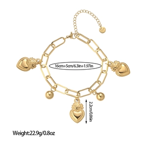 Macro detail of golden stainless steel bracelet featuring sacred heart charms and lobster clasp