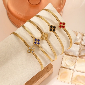 Luxury gold four-leaf clover bracelets in five colors on premium display stand