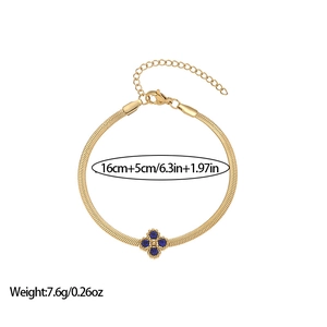 Detail of gold four-leaf clover bracelet with blue crystals and lobster clasp closure