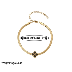 Elegant gold snake chain bracelet featuring a black four-leaf clover charm with size specs