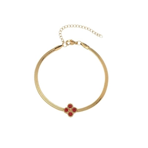 Elegant gold snake chain bracelet with a red four-leaf clover pendant and lobster clasp