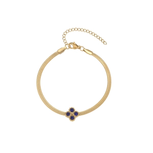 Detail of golden snake chain bracelet featuring a four-petal flower blue gemstone pendant