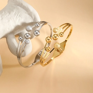 Elegant gold and silver multi-layer spring bangles with polished and matte spherical beads