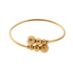 Detail of gold-plated bangle showing frosted and polished beads with open spring design