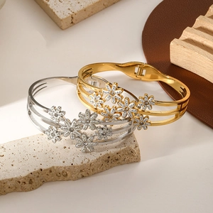 Elegant gold and silver titanium steel bracelets featuring hollow daisy floral designs