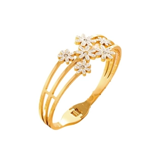 Close-up of golden stainless steel hollow daisy bracelet with crystal flower accents