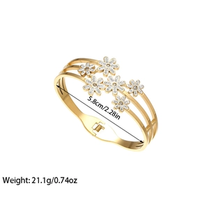 Elegant gold titanium snowflake cuff bracelet with white enamel daisy and crystals