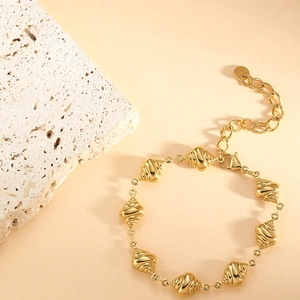 Detail view of gold croissant-link chain bracelet with lobster clasp and extension