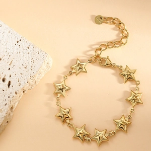 Detailed view of a gold-plated stainless steel star chain bracelet with lobster clasp