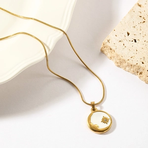 Golden stainless steel sunburst pendant necklace with a white inlay on a flat snake chain
