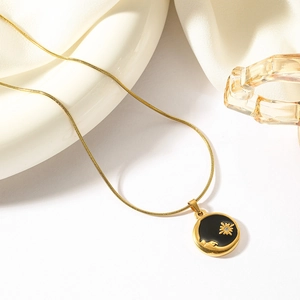 Golden sun and flower medallion necklace on snake chain with black enamel art finish