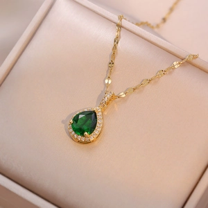 Elegant 18K gold-plated necklace with green teardrop zircon pendant on beige silk