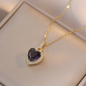 Elegant gold necklace featuring a purple heart gemstone pendant surrounded by white zircons