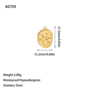 Macro detail of hammered gold stainless steel oval pendant with star and moon relief